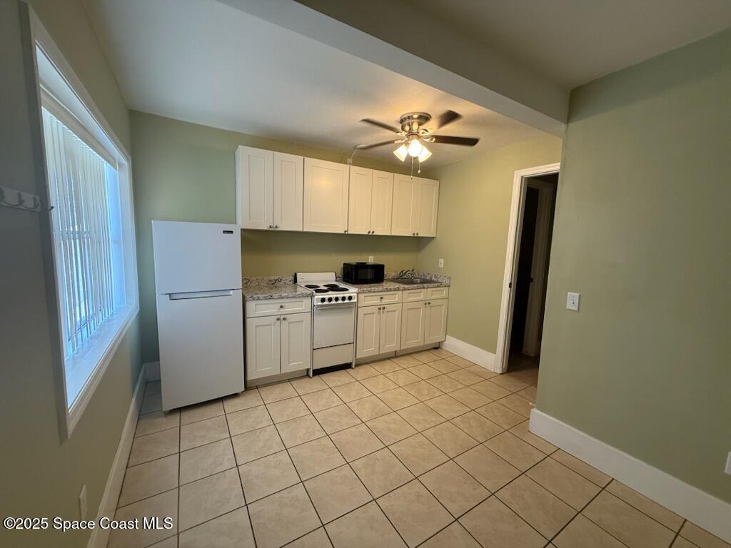 3485 Highway 1, Unit 6 Mims, FL 32754 - Photo 2 of 4 a kitchen with a sink a refrigerator and cabinets