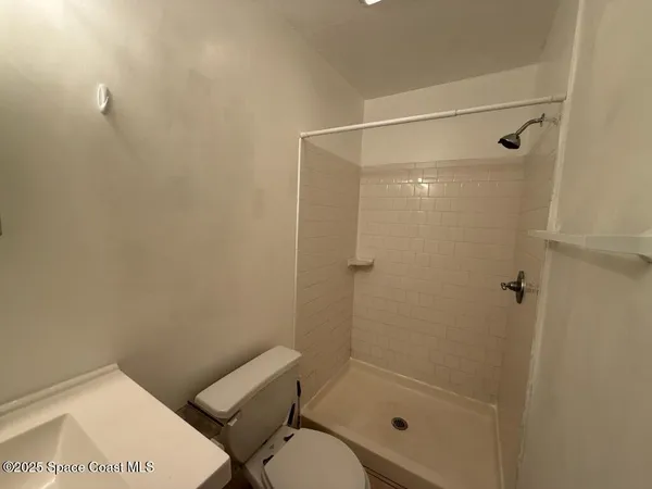 a bathroom with a shower and toilet