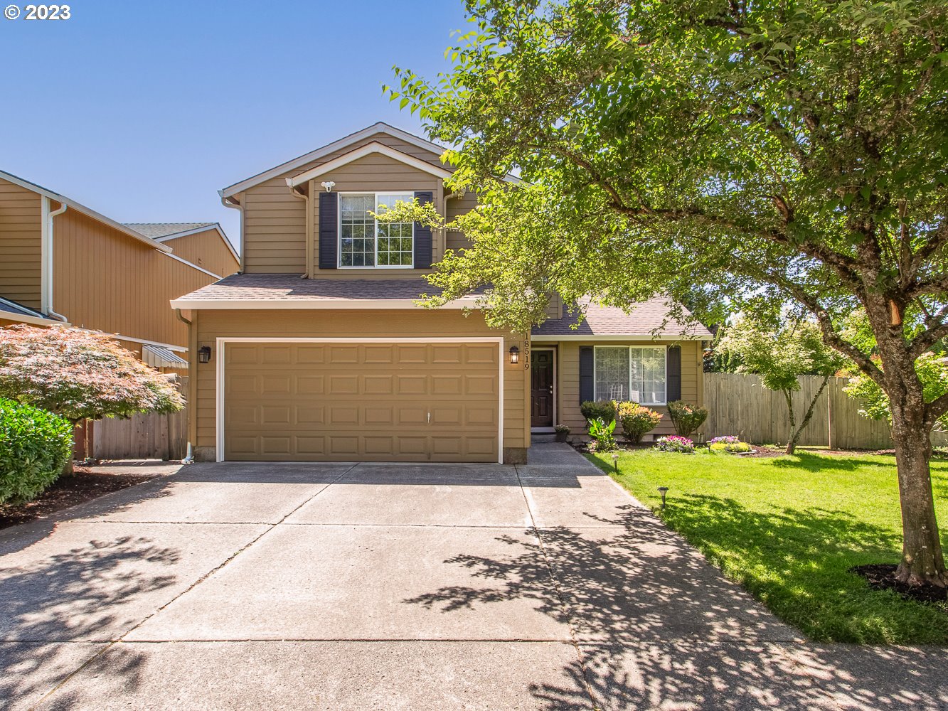 a front view of a house with a yard and garage