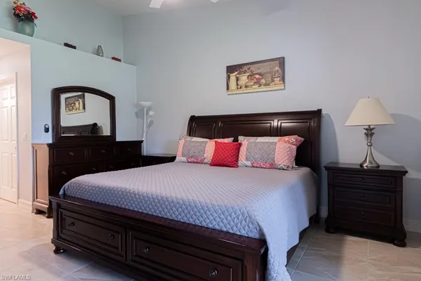 a bedroom with a bed and a television