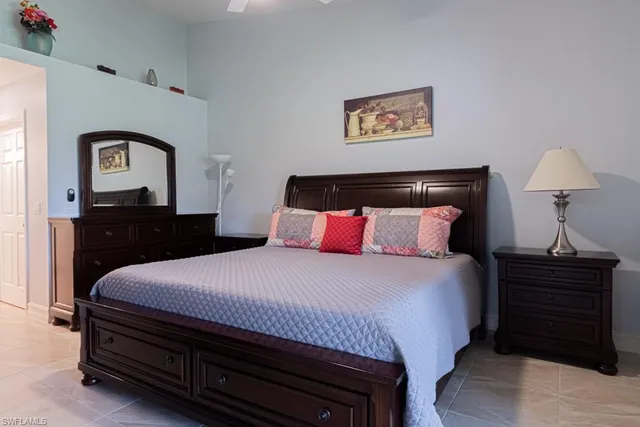 a bedroom with a bed and a television