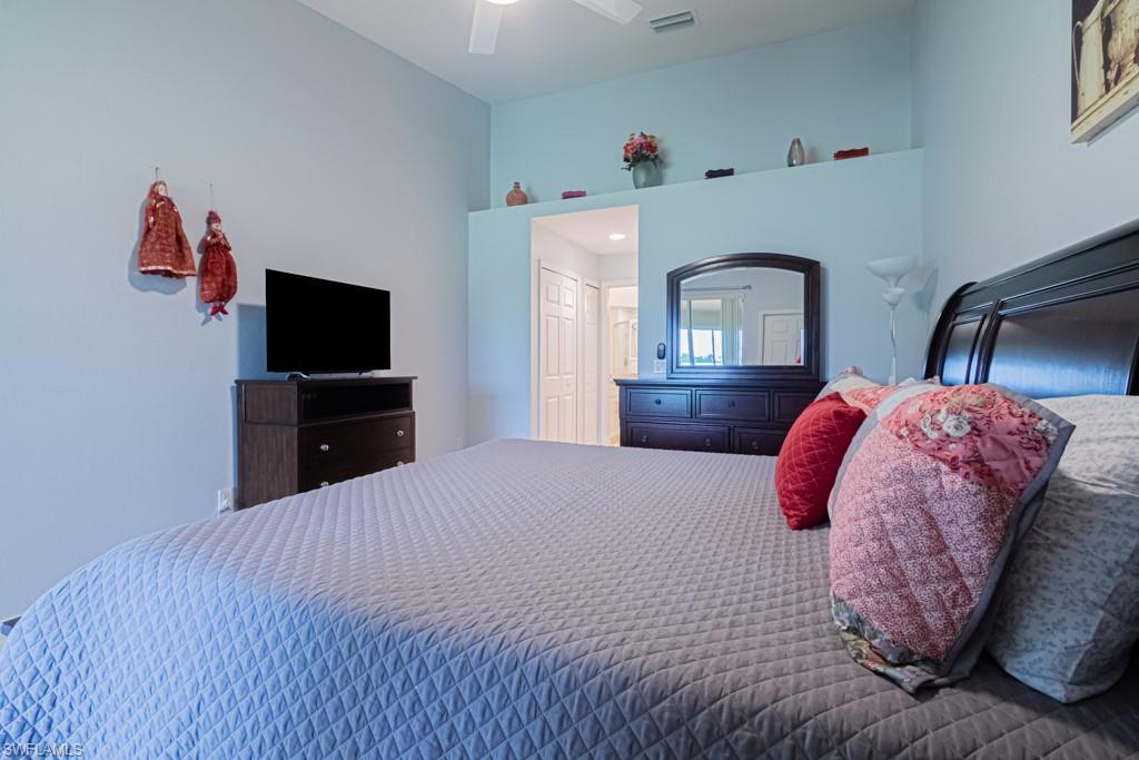 6015 Pinnacle Lane, Unit 5 Naples, FL 34110 - Photo 13 of 25 a bedroom with a bed and a television