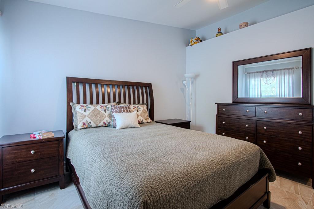 6015 Pinnacle Lane, Unit 5 Naples, FL 34110 - Photo 19 of 25 a bedroom with a bed and a night stand