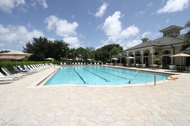 6015 Pinnacle Lane, Unit 5 Naples, FL 34110 - Photo 23 of 25 a view of a house with swimming pool and a yard