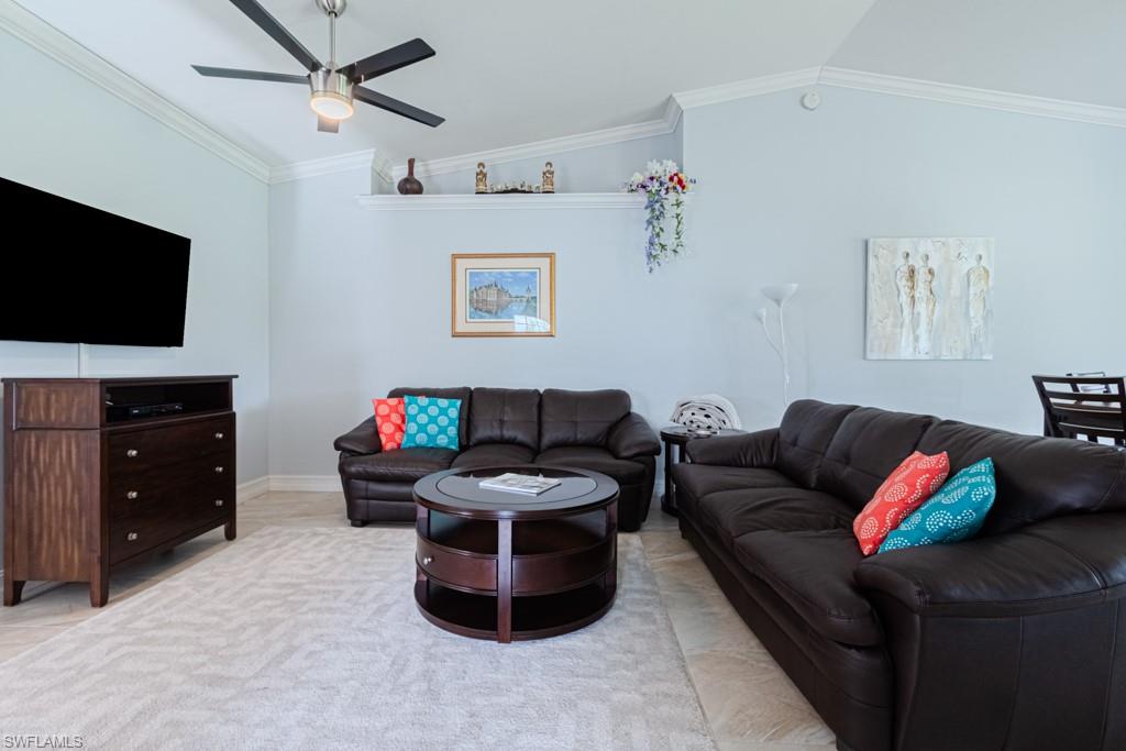 6015 Pinnacle Lane, Unit 5 Naples, FL 34110 - Photo 4 of 25 a living room with furniture and a flat screen tv