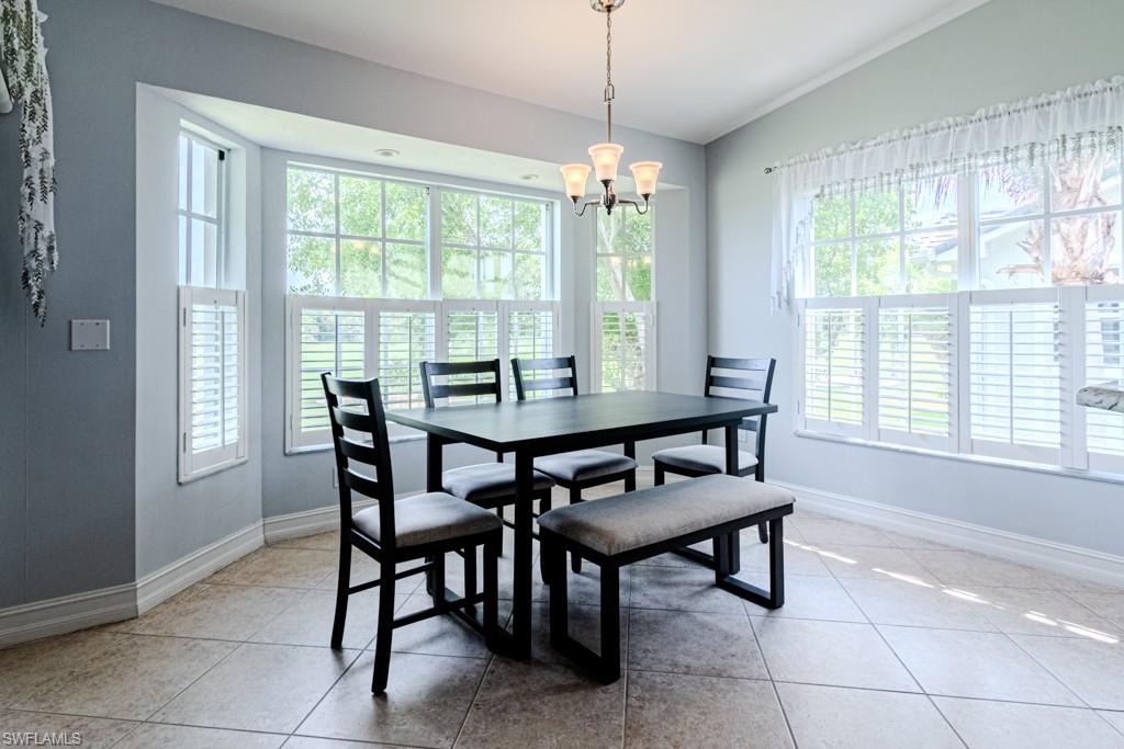 6015 Pinnacle Lane, Unit 5 Naples, FL 34110 - Photo 7 of 25 a dining room with furniture and window
