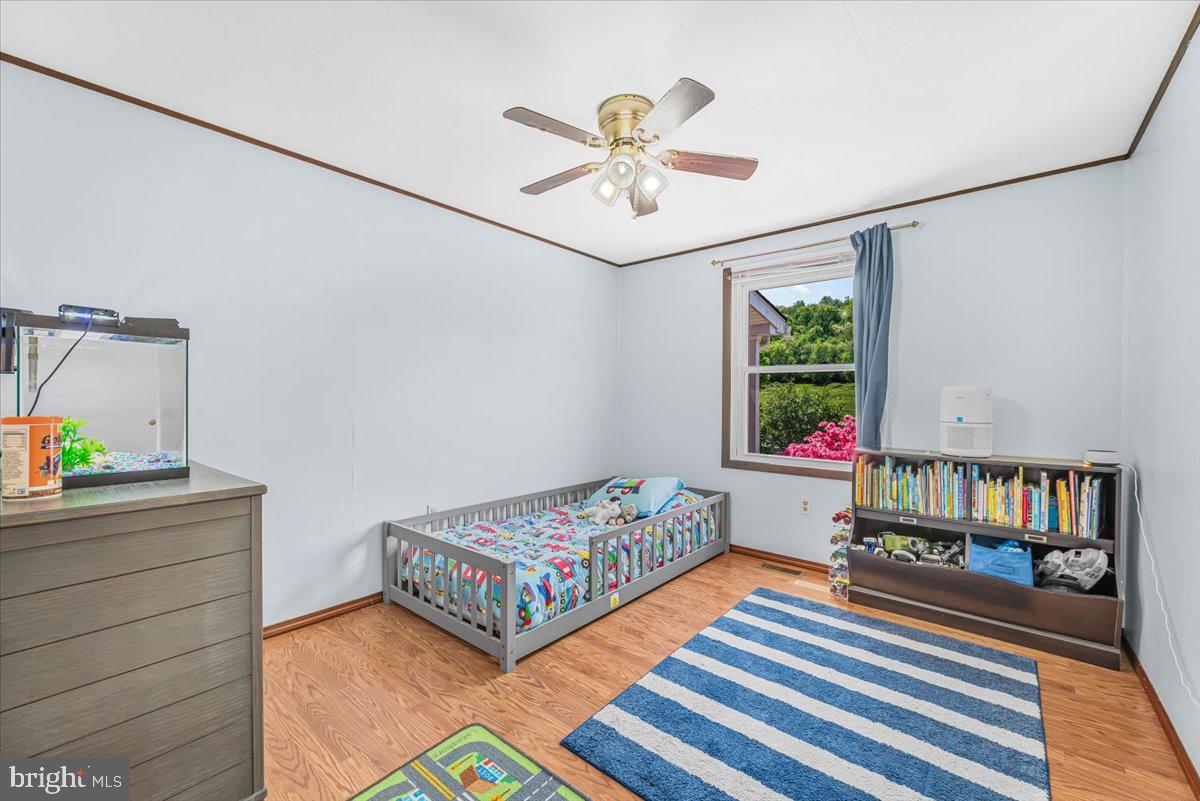 14011 Pryor Road Thurmont, MD 21788 - Photo 17 of 38 a bedroom with a bed and a book shelf