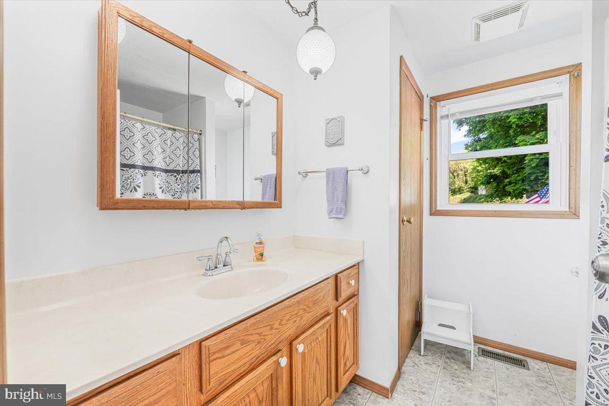 14011 Pryor Road Thurmont, MD 21788 - Photo 18 of 38 a bathroom with a sink a toilet and a mirror
