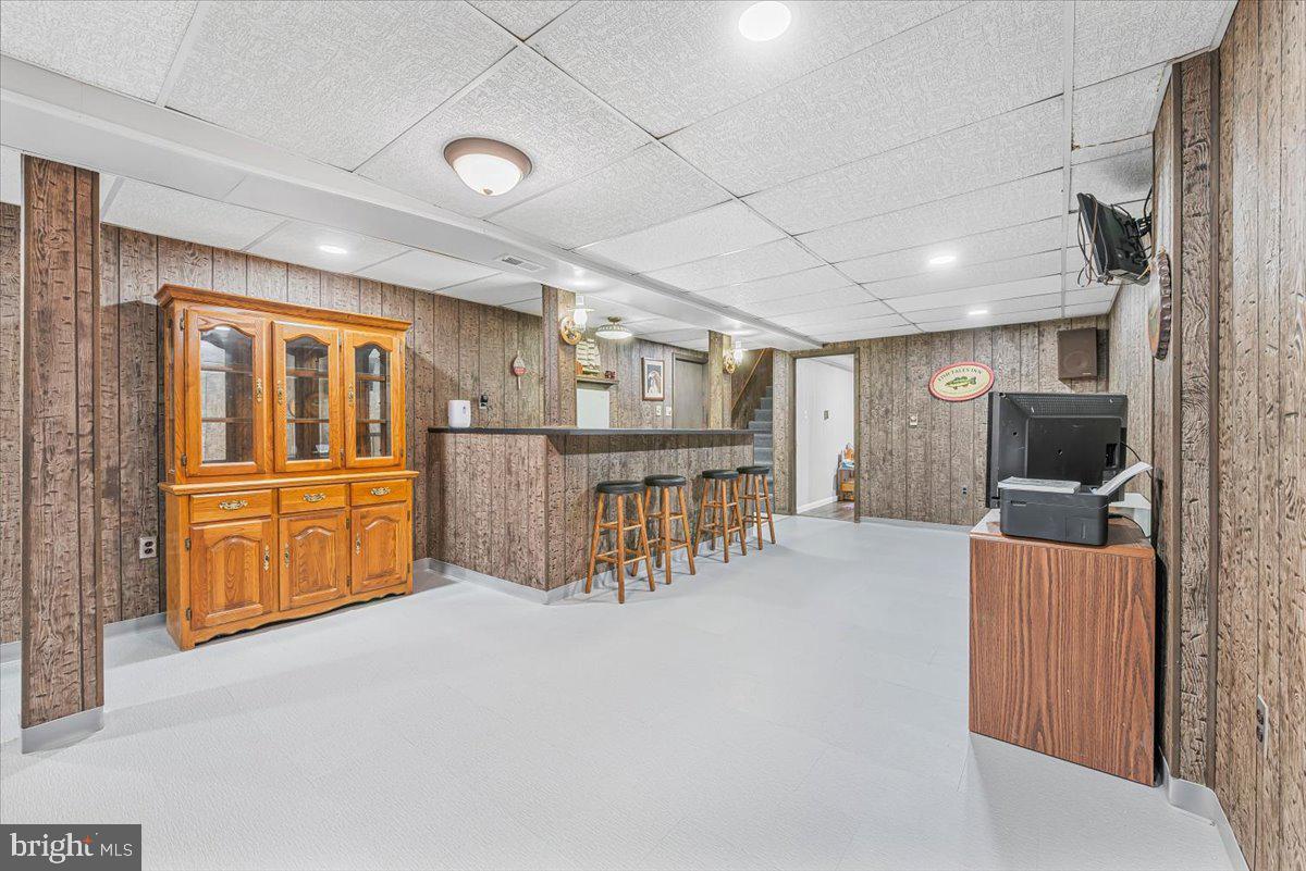 14011 Pryor Road Thurmont, MD 21788 - Photo 27 of 38 a living room with furniture a flat screen tv and kitchen view