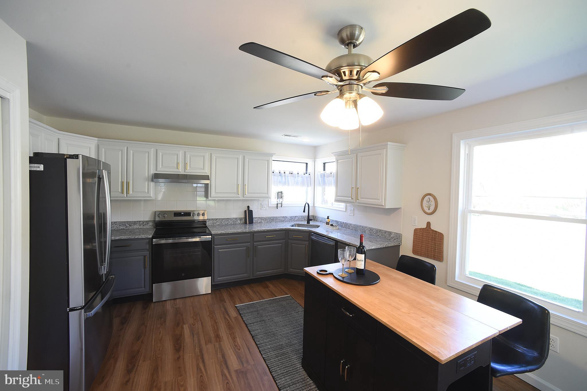 4 Deep Hollow Lane North Columbus, NJ 08022 - Photo 6 of 27 a kitchen with a refrigerator a sink dishwasher a stove and a refrigerator with wooden floor