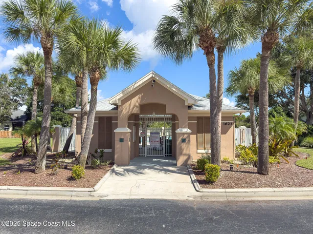 a front view of a house with tree s