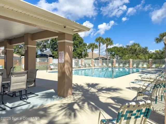 a view of a patio with table and chairs and potted plants