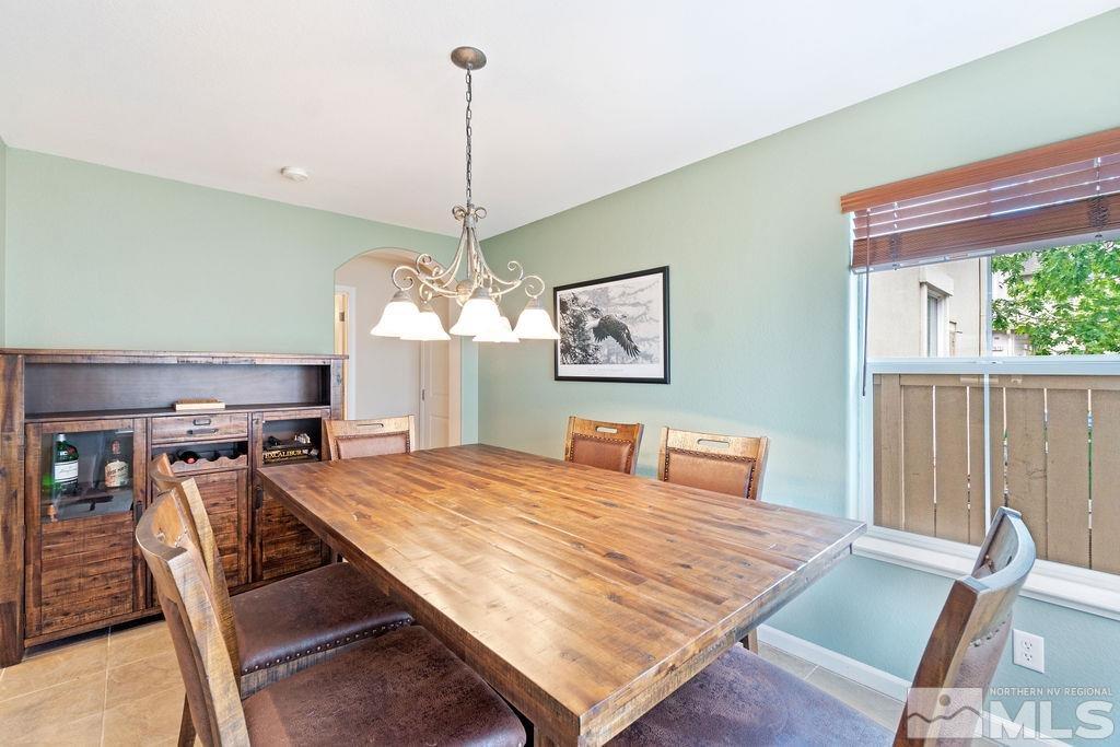 7686 Pebblestone Way Reno, NV 89523 - Photo 18 of 35 a view of a dining room with furniture window and wooden floor