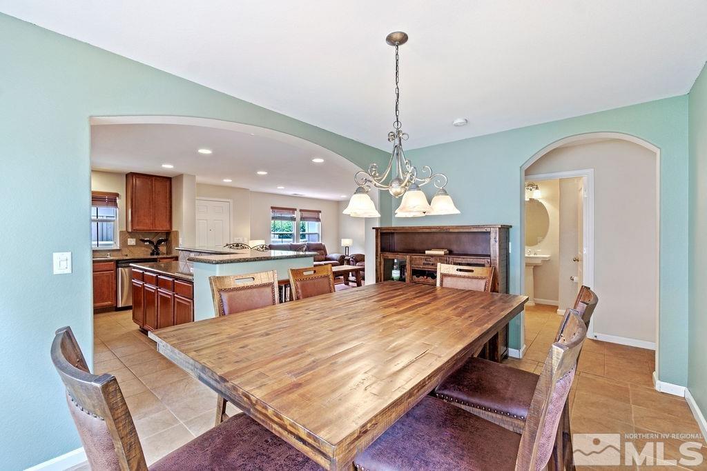 7686 Pebblestone Way Reno, NV 89523 - Photo 19 of 35 a dining room with a table or chairs and a kitchen view