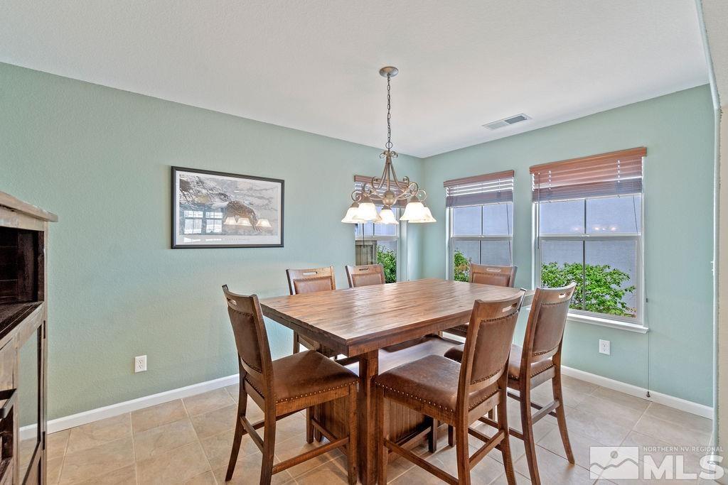 7686 Pebblestone Way Reno, NV 89523 - Photo 21 of 35 a dining room with furniture a chandelier and window