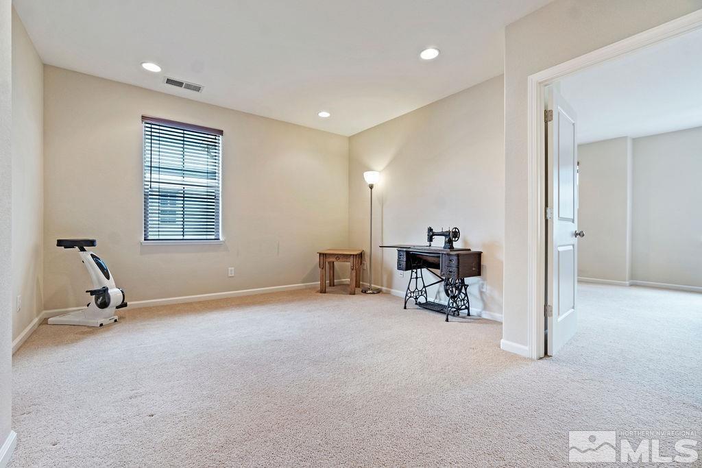 7686 Pebblestone Way Reno, NV 89523 - Photo 22 of 35 a view of a room with gym equipment and a mirror