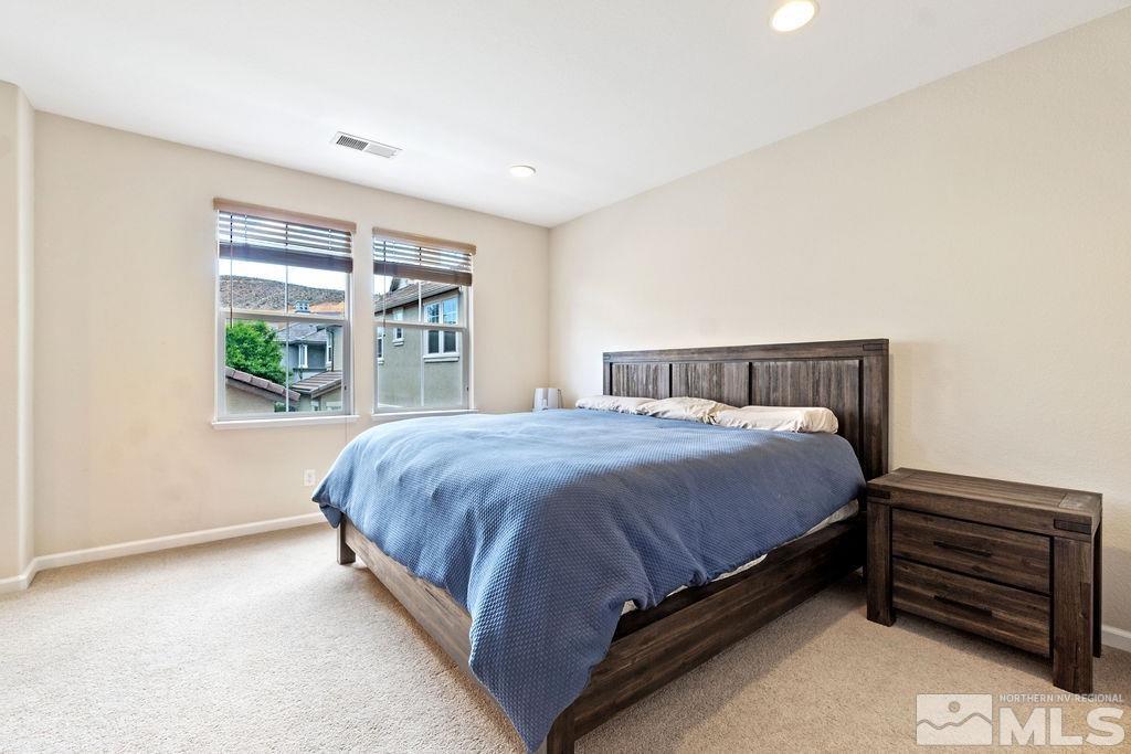 7686 Pebblestone Way Reno, NV 89523 - Photo 24 of 35 a bed sitting in a bedroom next to a window