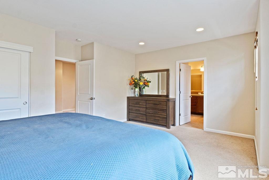 7686 Pebblestone Way Reno, NV 89523 - Photo 26 of 35 a bedroom with a bed and wooden floor