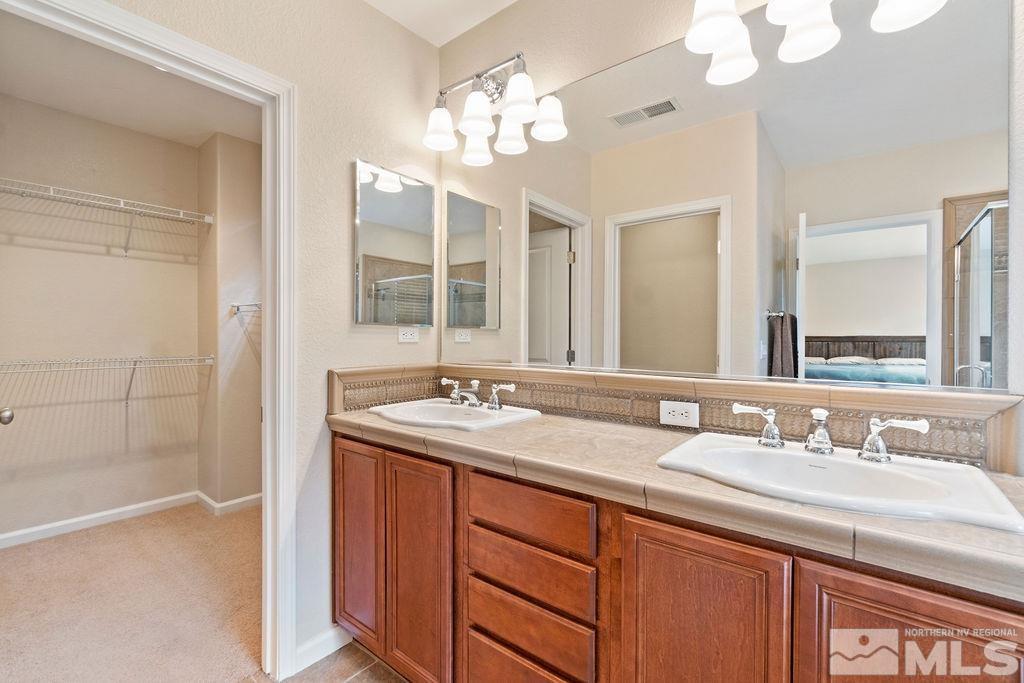 7686 Pebblestone Way Reno, NV 89523 - Photo 28 of 35 a bathroom with a sink double vanity and a mirror