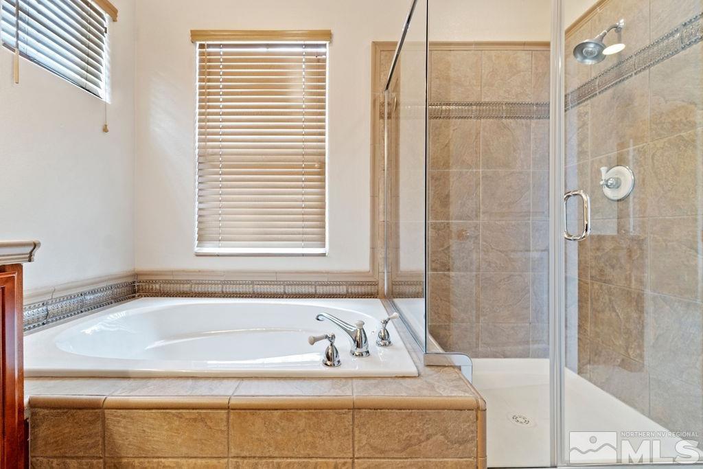 7686 Pebblestone Way Reno, NV 89523 - Photo 29 of 35 a bathroom with a bathtub and a shower