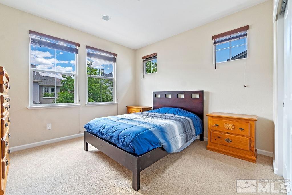 7686 Pebblestone Way Reno, NV 89523 - Photo 31 of 35 a bed sitting in a bedroom next to a window