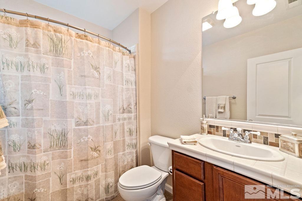 7686 Pebblestone Way Reno, NV 89523 - Photo 33 of 35 a bathroom with a sink a toilet and shower