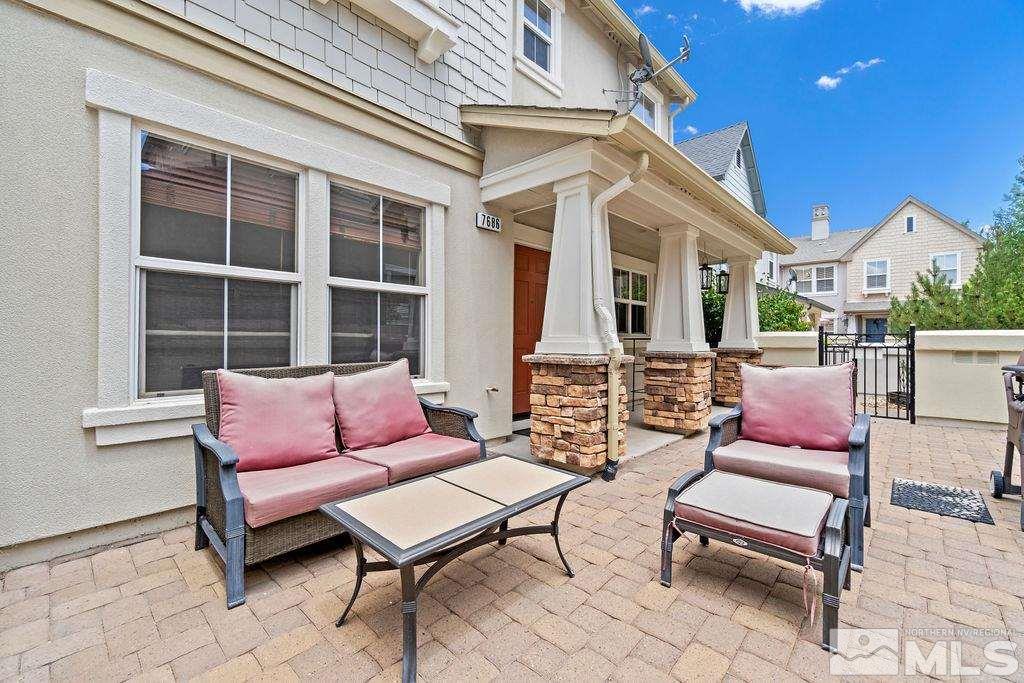 7686 Pebblestone Way Reno, NV 89523 - Photo 5 of 35 a outdoor living space with furniture and a potted plant