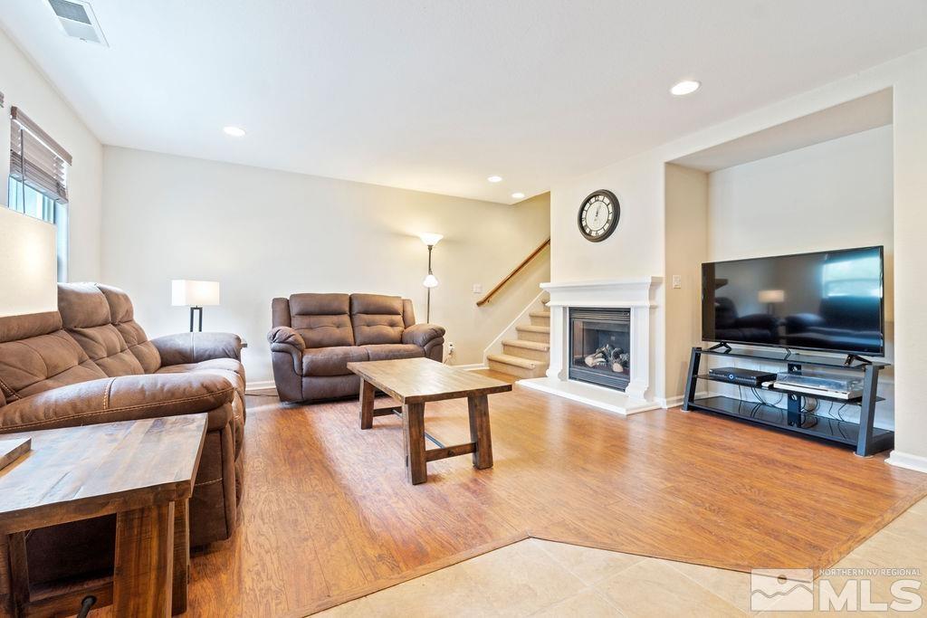 7686 Pebblestone Way Reno, NV 89523 - Photo 7 of 35 a living room with furniture and a flat screen tv