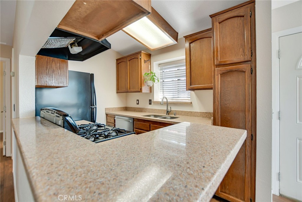9505 Arlington Avenue, Unit 89 Riverside, CA 92503 - Photo 11 of 26 a kitchen with stainless steel appliances granite countertop a sink stove and refrigerator
