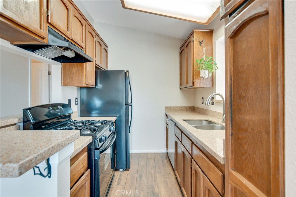 9505 Arlington Avenue, Unit 89 Riverside, CA 92503 - Photo 12 of 26 a kitchen with stainless steel appliances granite countertop a stove and a refrigerator