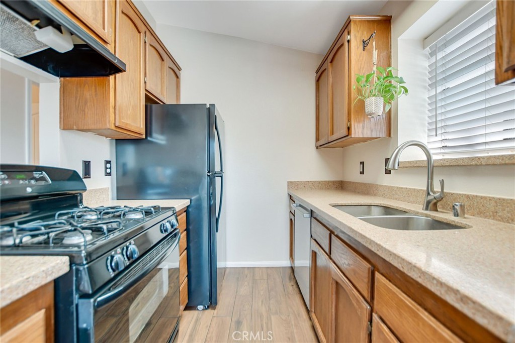 9505 Arlington Avenue, Unit 89 Riverside, CA 92503 - Photo 13 of 26 a kitchen with stainless steel appliances granite countertop a sink stove and cabinets
