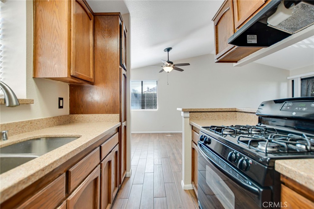 9505 Arlington Avenue, Unit 89 Riverside, CA 92503 - Photo 14 of 26 a kitchen with stainless steel appliances granite countertop a sink stove and cabinets