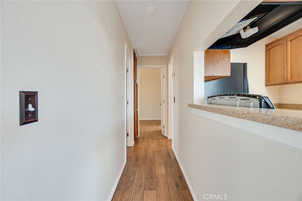 9505 Arlington Avenue, Unit 89 Riverside, CA 92503 - Photo 15 of 26 a view of hallway with wooden floor