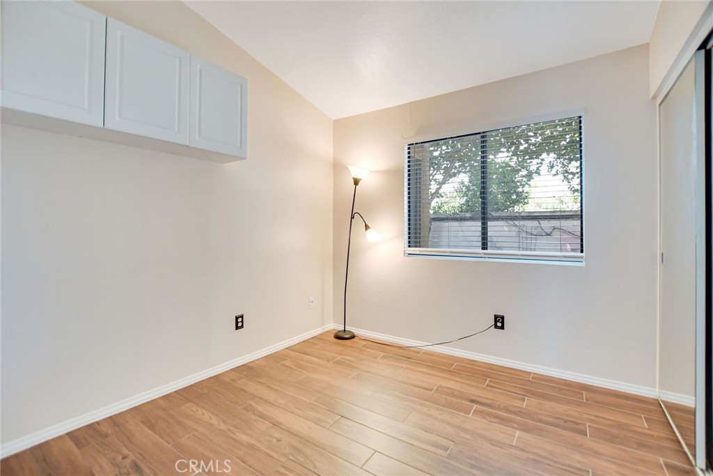 9505 Arlington Avenue, Unit 89 Riverside, CA 92503 - Photo 16 of 26 an empty room with wooden floor and windows
