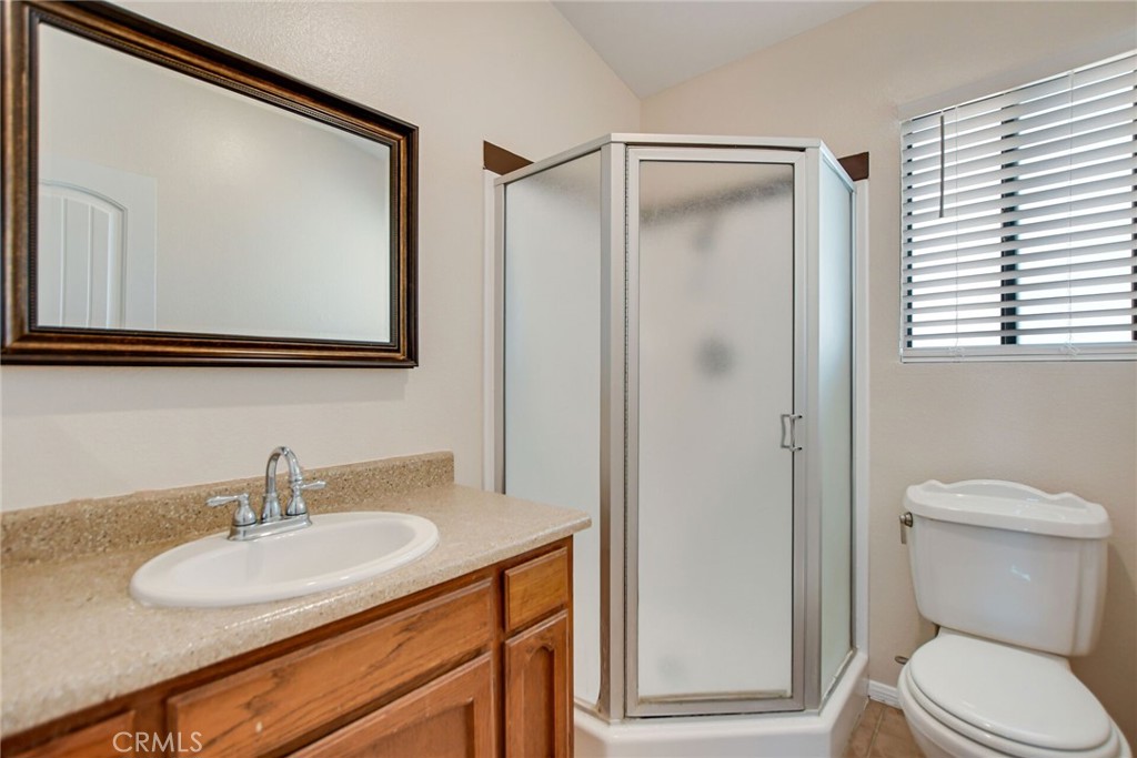 9505 Arlington Avenue, Unit 89 Riverside, CA 92503 - Photo 17 of 26 a bathroom with a toilet a sink and mirror
