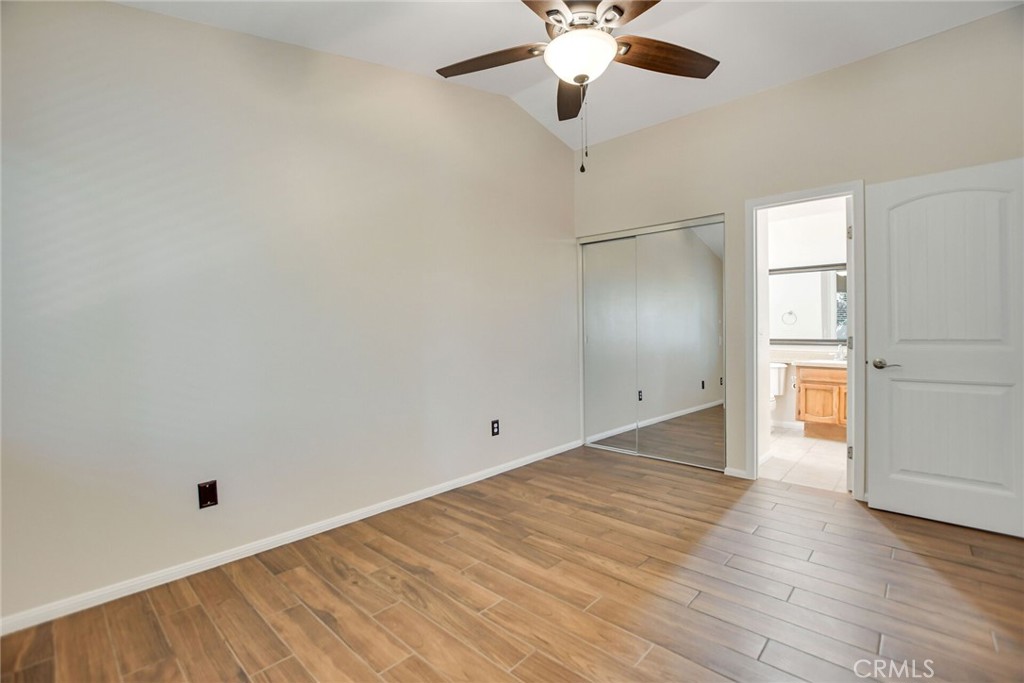 9505 Arlington Avenue, Unit 89 Riverside, CA 92503 - Photo 18 of 26 an empty room with wooden floor fan and windows