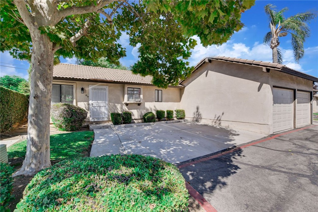 9505 Arlington Avenue, Unit 89 Riverside, CA 92503 - Photo 2 of 26 a view of a house with backyard and a garden