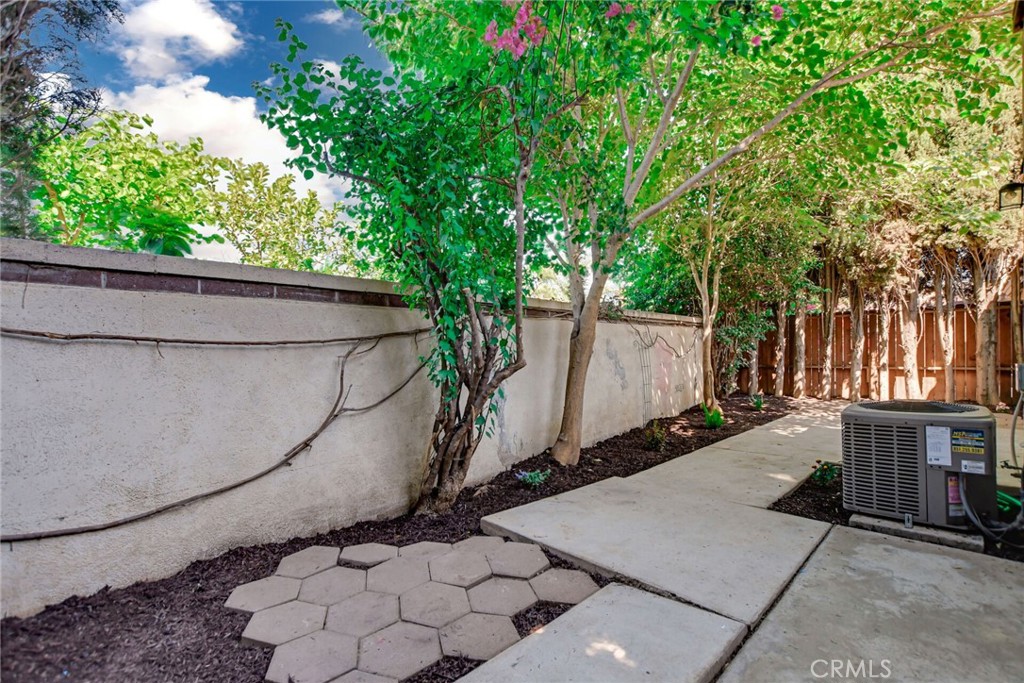 9505 Arlington Avenue, Unit 89 Riverside, CA 92503 - Photo 22 of 26 a backyard of a house with lots of green space and glass windows