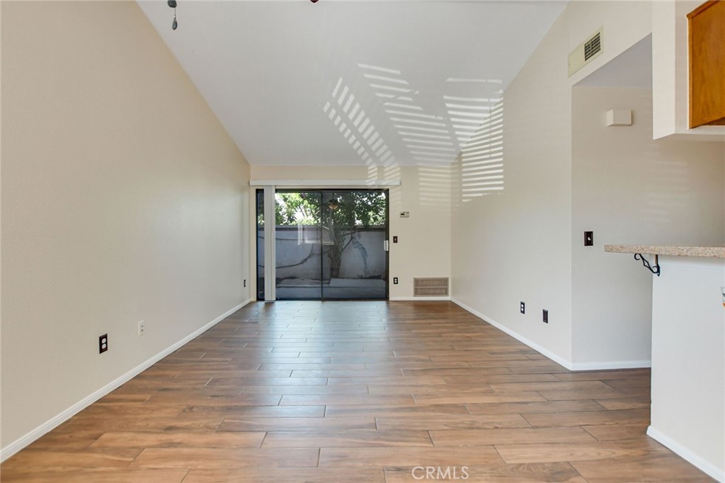 9505 Arlington Avenue, Unit 89 Riverside, CA 92503 - Photo 7 of 26 a view of an empty room with wooden floor and a window