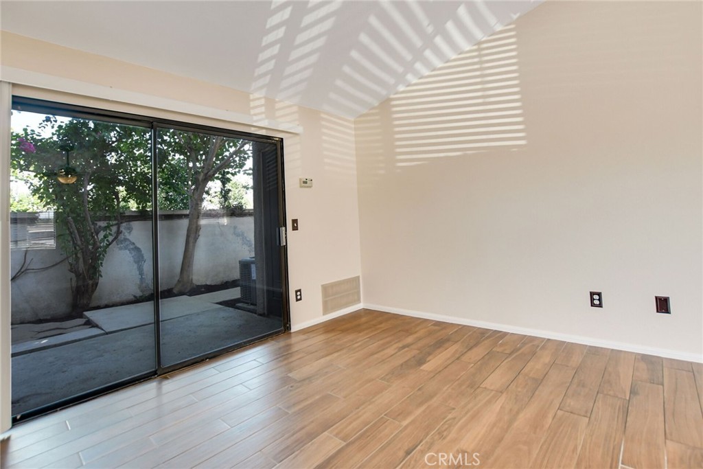 9505 Arlington Avenue, Unit 89 Riverside, CA 92503 - Photo 9 of 26 a view of a room with wooden floor and glass door