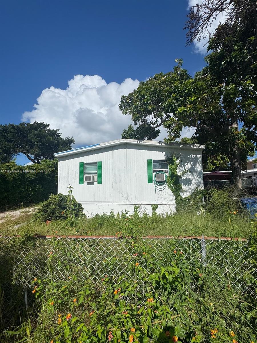 13 Judy Place Key Largo, FL 33037 - Photo 2 of 8 front view of a house with a yard