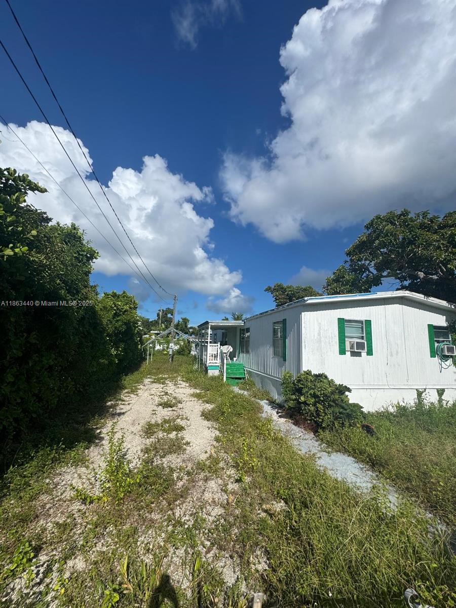 13 Judy Place Key Largo, FL 33037 - Photo 5 of 8 a view of a house with a yard