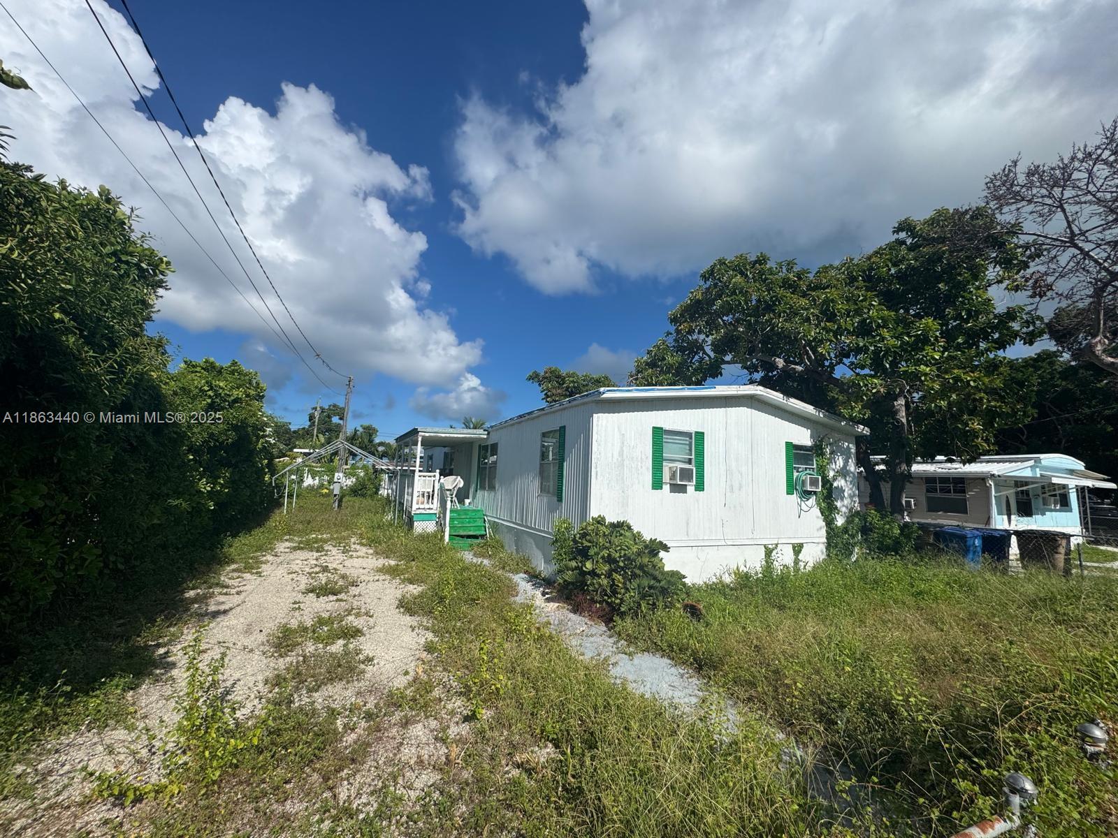 13 Judy Place Key Largo, FL 33037 - Photo 7 of 8 a front view of a house with garden