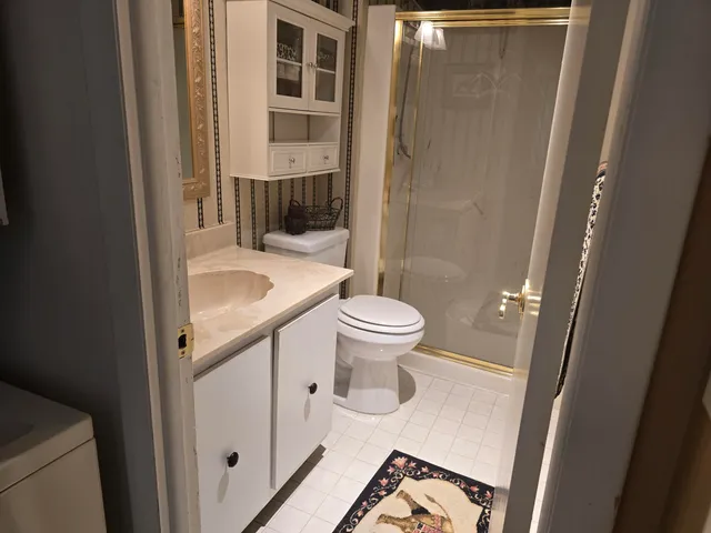 a bathroom with a sink toilet and shower