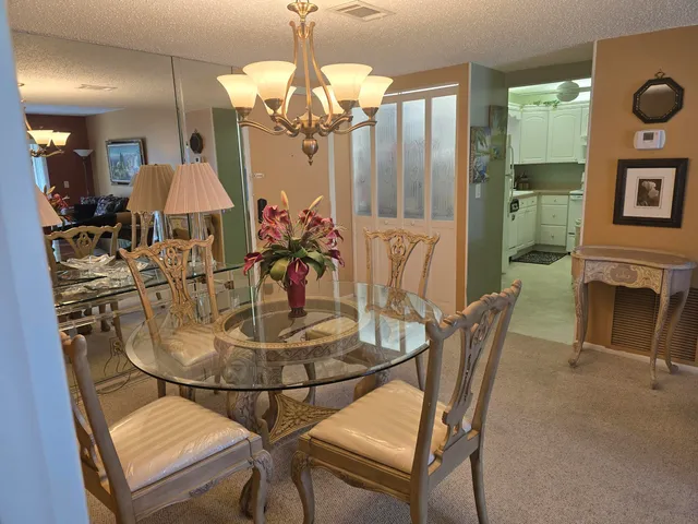 a dining room with furniture and chandelier