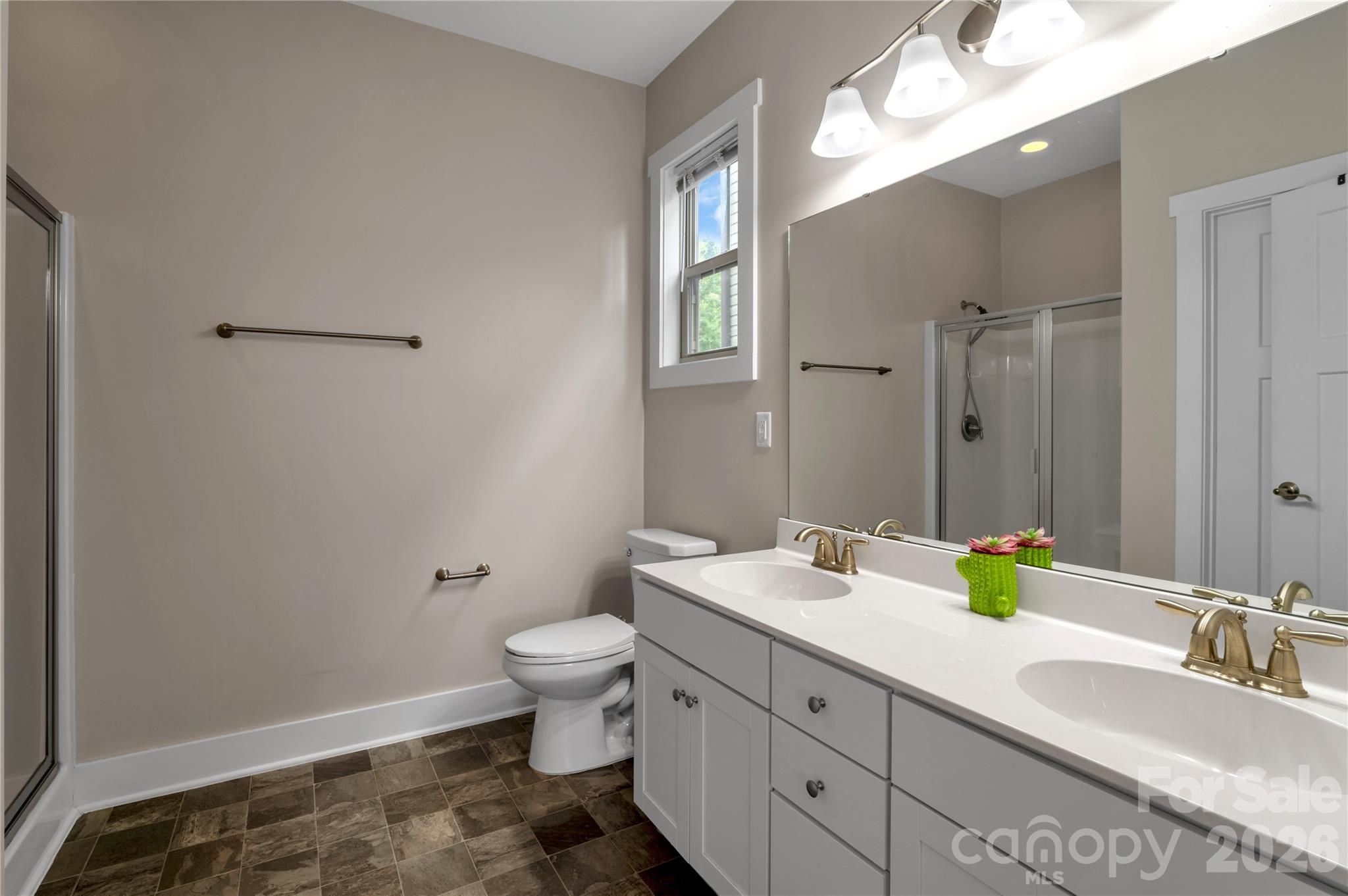 27 Mann Lane Fletcher, NC 28732 - Photo 12 of 25 a bathroom with a double vanity sink toilet and a mirror