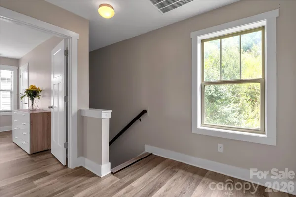 a view of an entryway with wooden floor and a window