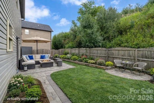 a view of a backyard with sitting area and furniture