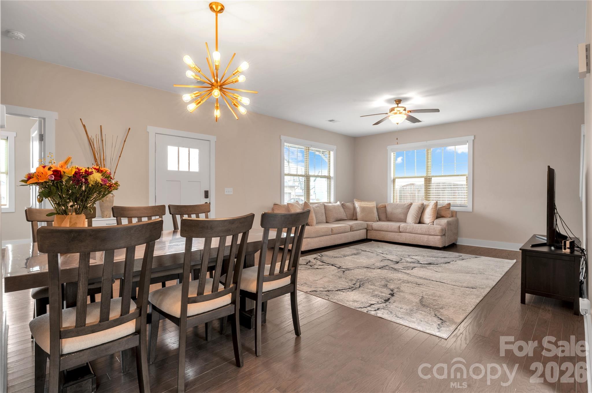 27 Mann Lane Fletcher, NC 28732 - Photo 4 of 25 a living room with furniture a chandelier a rug and a window