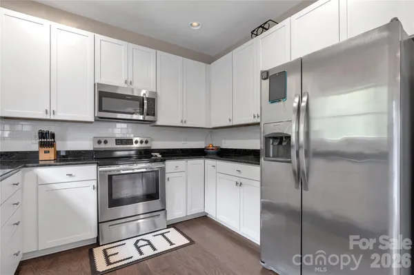 a kitchen with cabinets and stainless steel appliances